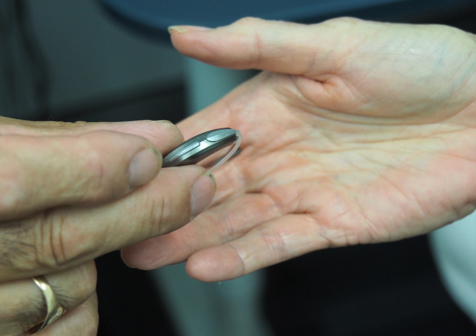 person holding hearing aid