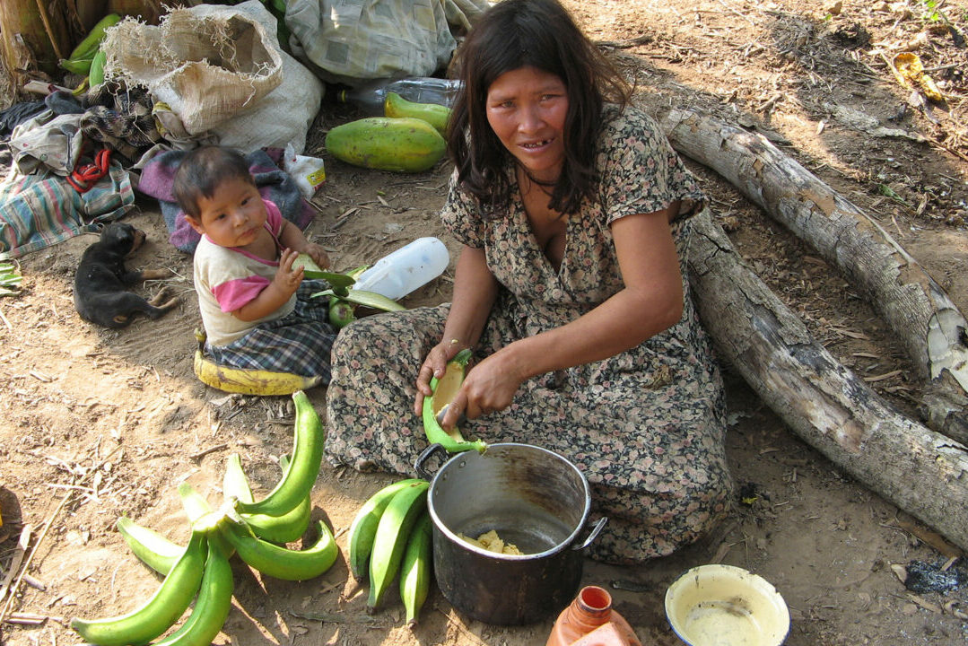 Tsimane woman scoops out banana
